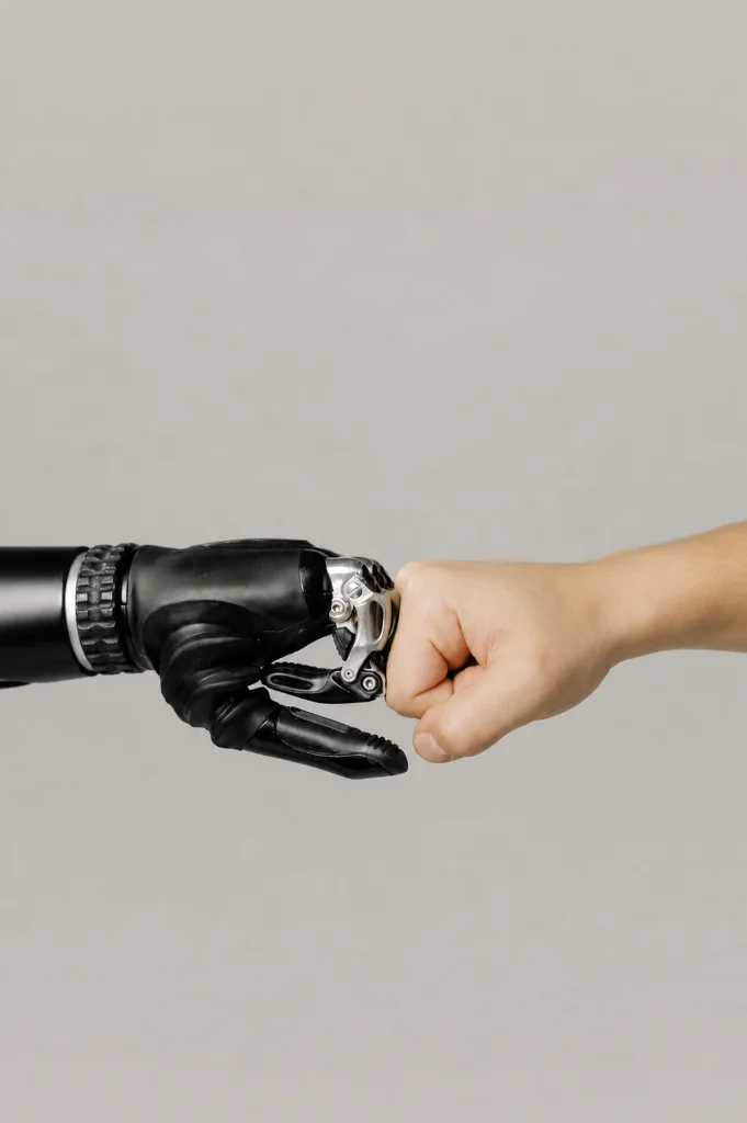 Human and robot fist bump symbolizing partnership